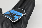 Side angle view showing 3D layered detail of light blue BMW M3 G80 keychain by LayerPlay Pocket Motors