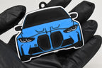 3D printed light blue BMW M3 G80 keychain held in hand, front view detail by LayerPlay Pocket Motors