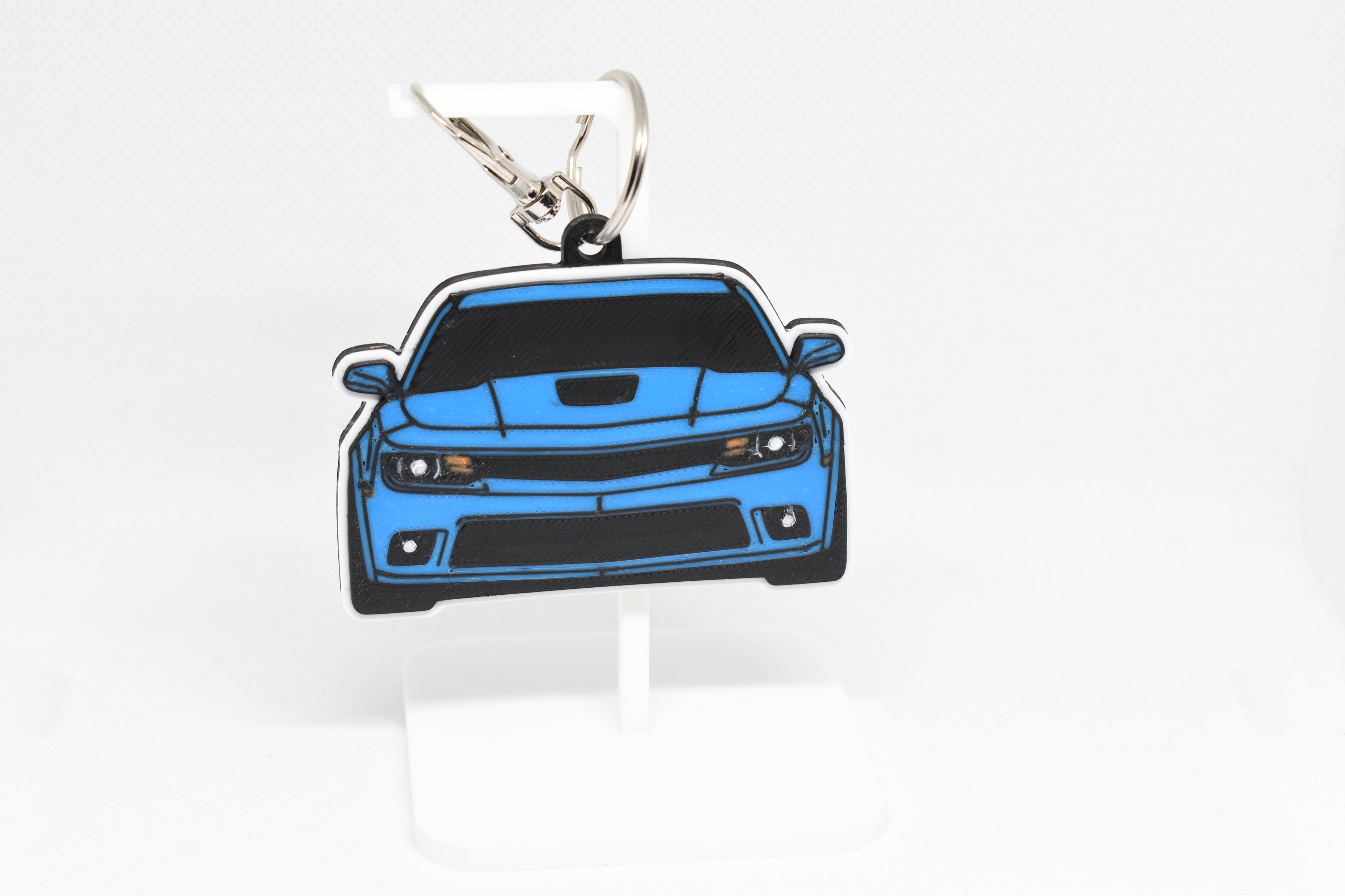 Pocket Motors Camaro SS 5th Gen facelift keychain displayed on a white stand with metal ring and clip.