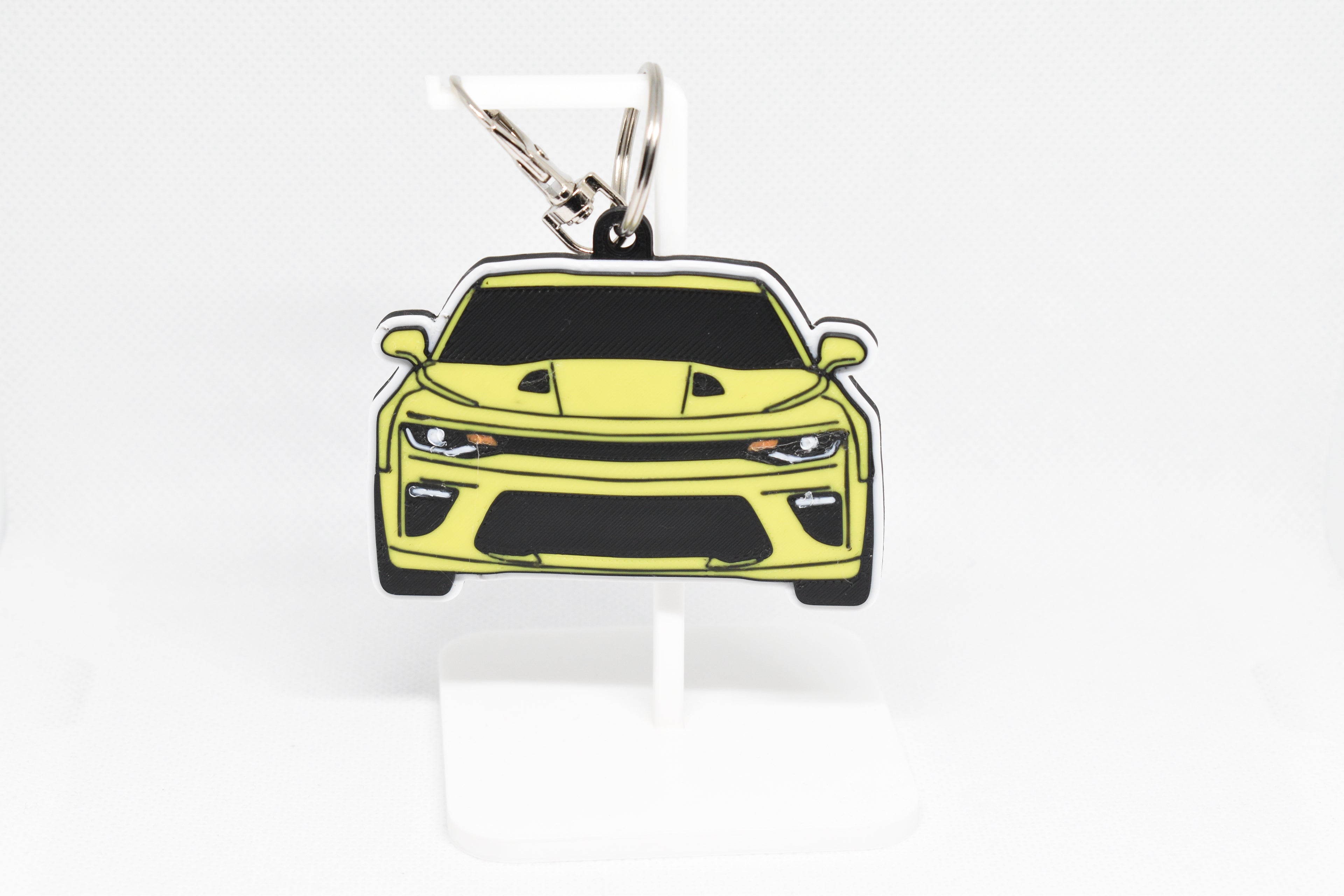 Pocket Motors Camaro SS 6th Gen keychain displayed on a white stand with metal ring and clip.