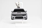 Pocket Motors Charger Hellcat keychain displayed on a white stand with metal ring and clip.