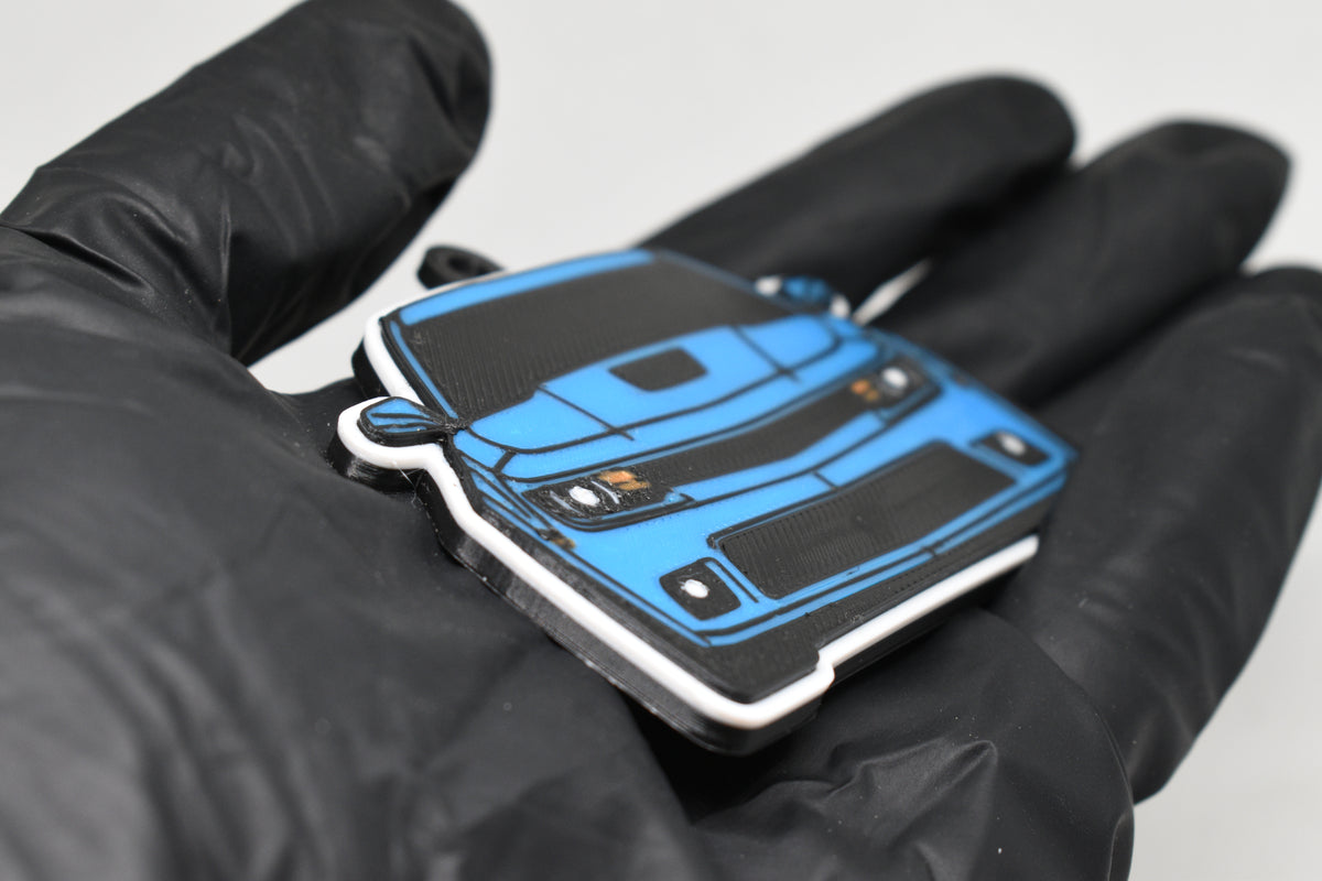 Side angle view showing 3D layered detail of light blue Chevrolet Camaro SS 5th Gen facelift keychain by LayerPlay Pocket Motors