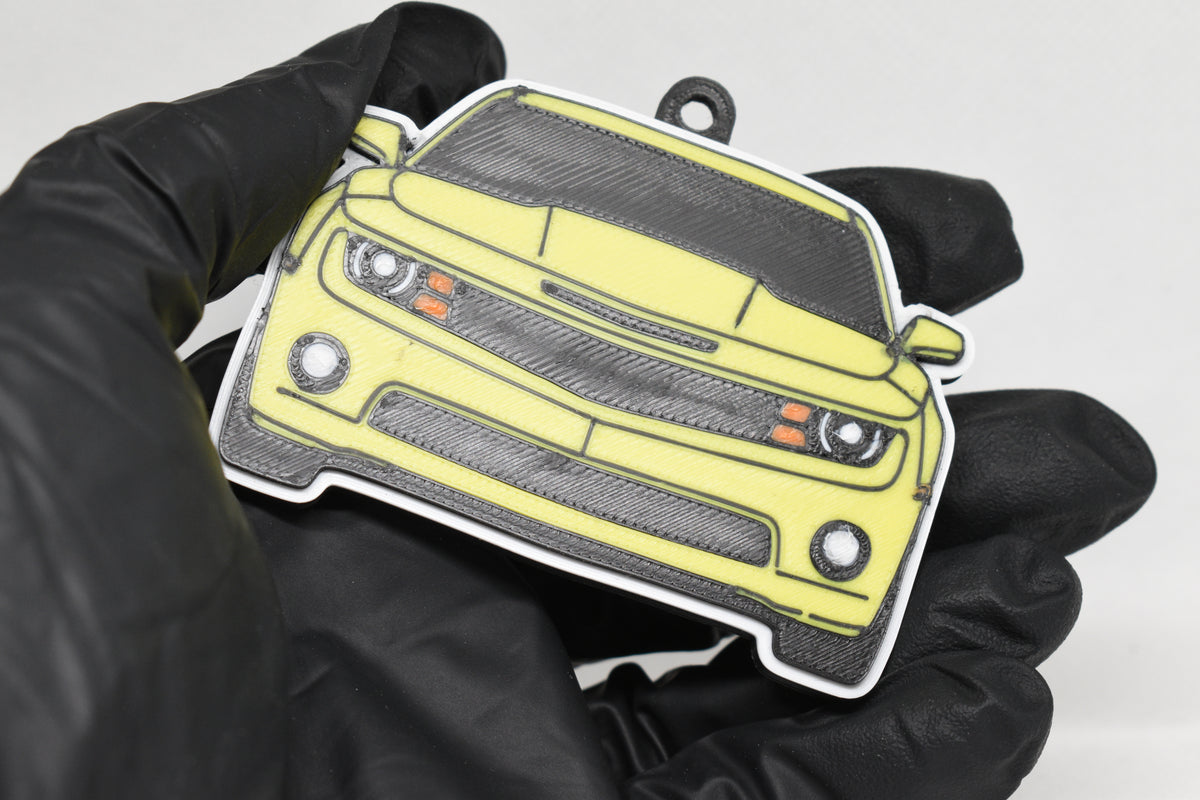 3D printed yellow Chevrolet Camaro SS 5th Gen keychain held in hand, front view detail by LayerPlay Pocket Motors