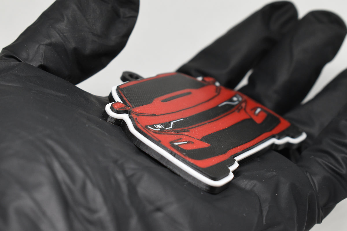 Side angle view showing 3D layered detail of red Chevrolet Camaro SS 6th Gen facelift keychain by LayerPlay Pocket Motors