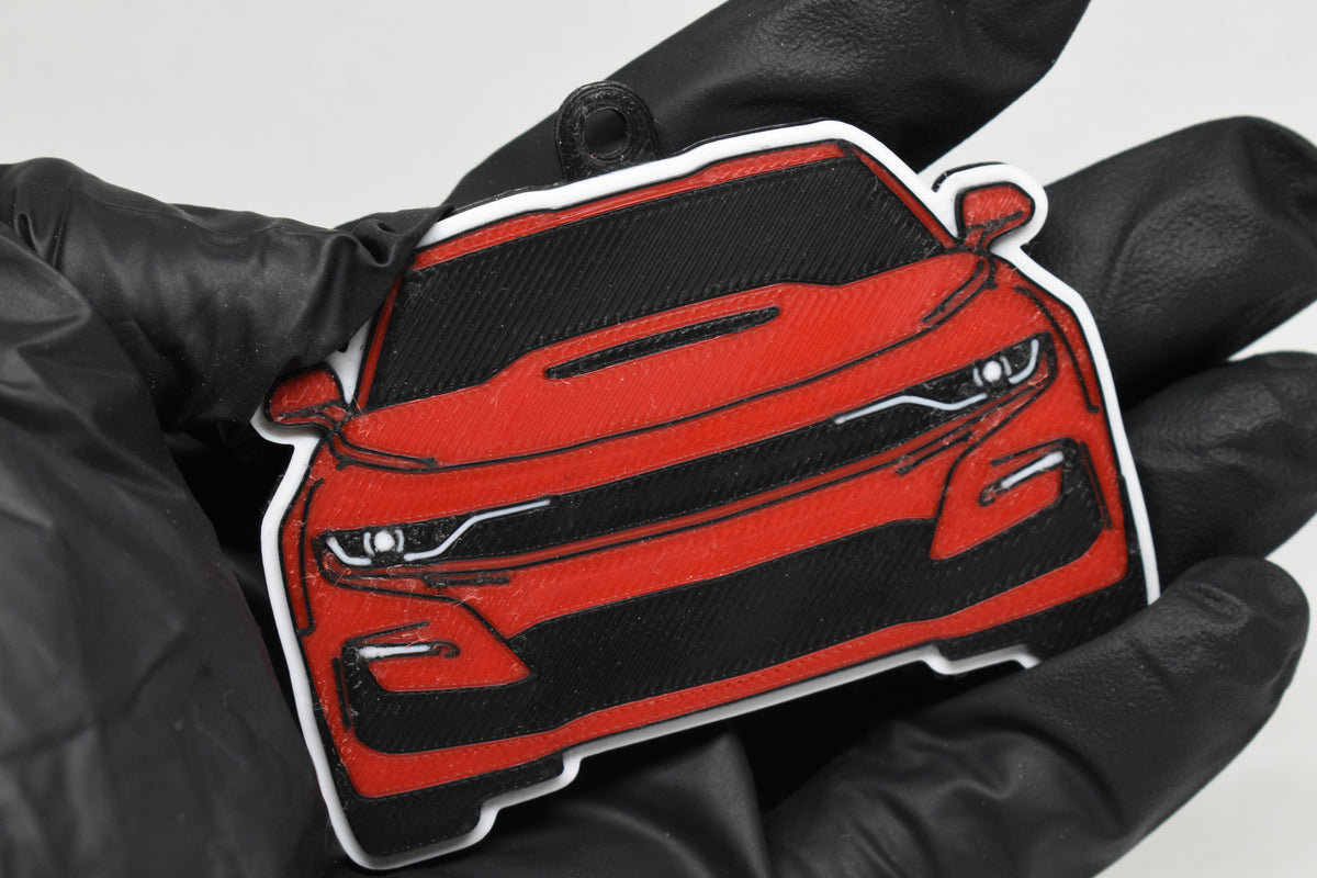 3D printed red Chevrolet Camaro SS 6th Gen facelift keychain held in hand, front view detail by LayerPlay Pocket Motors