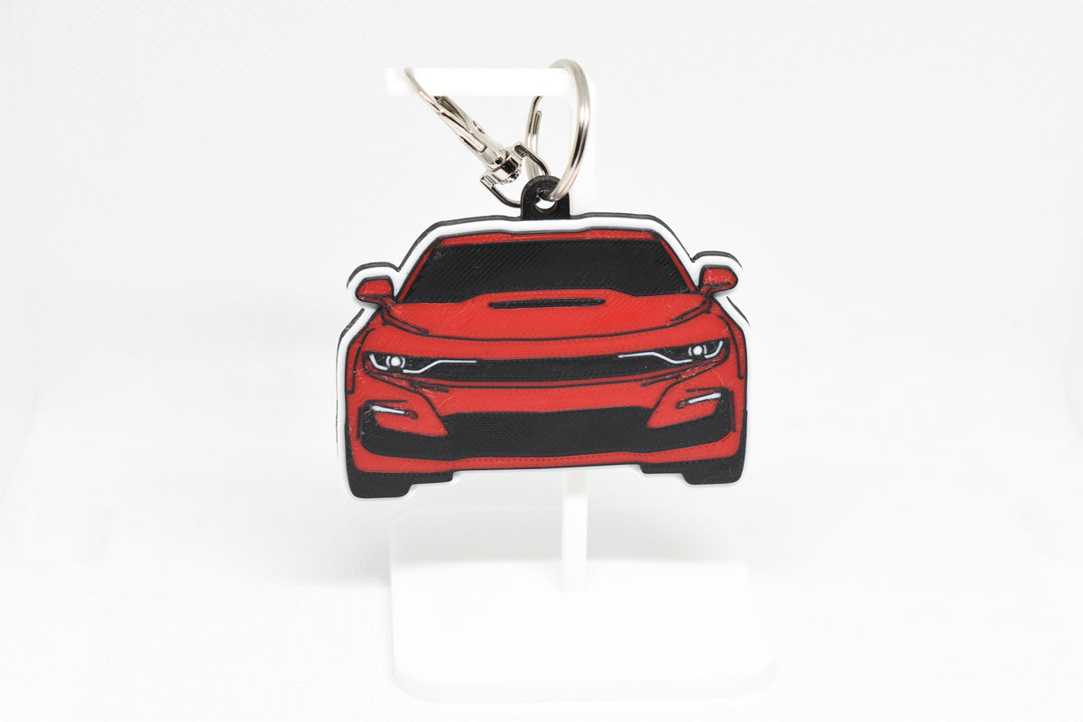 Pocket Motors Chevrolet Camaro SS 6th Gen facelift keychain displayed on a white stand with metal ring and clip.