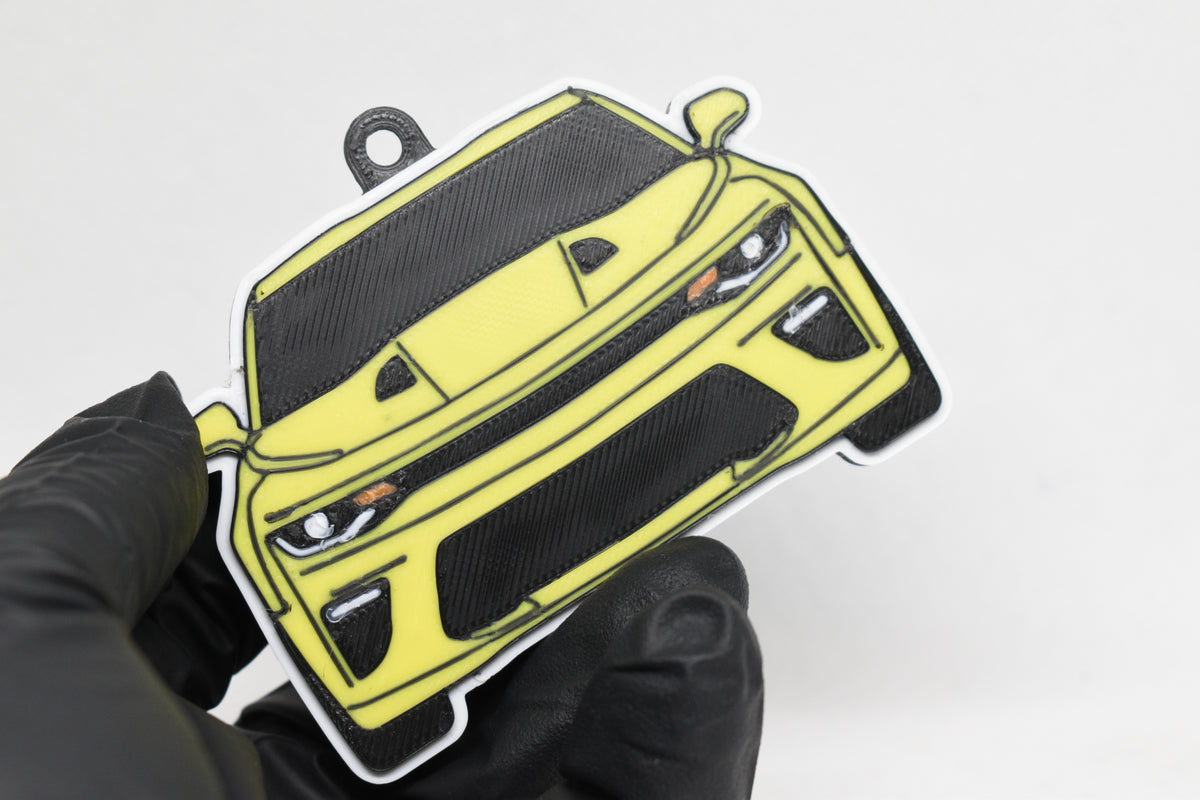 3D printed yellow Chevrolet Camaro SS 6th Gen keychain held in hand, front view detail by LayerPlay Pocket Motors