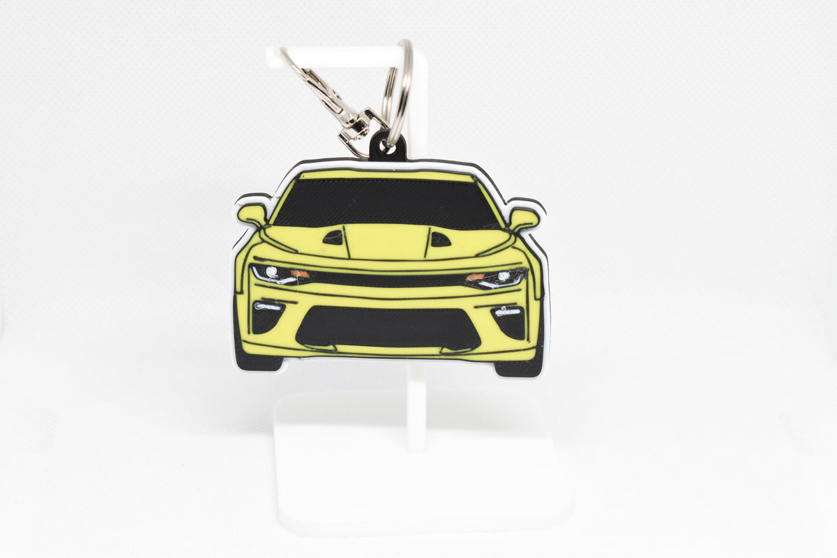 3D printed yellow Chevrolet Camaro SS 6th Gen keychain held in hand, front view detail by LayerPlay Pocket Motors