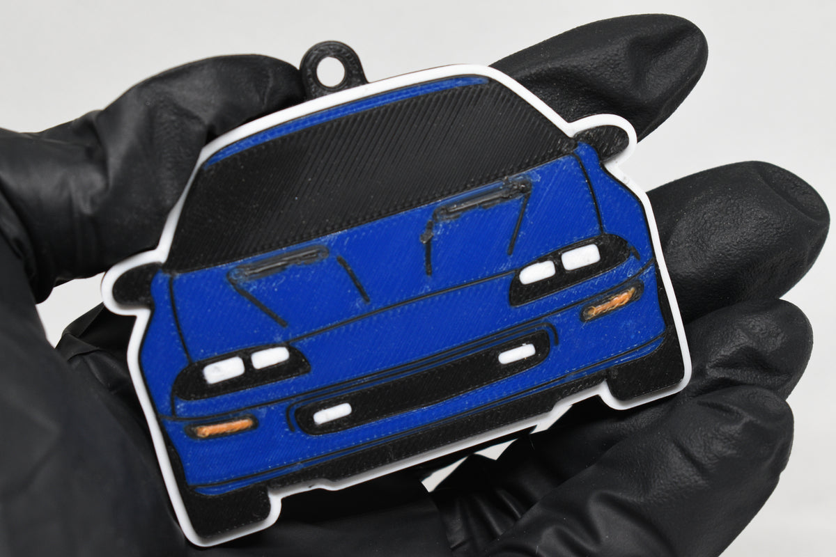 3D printed blue Chevrolet Camaro Z28 4th Gen keychain held in hand, front view detail by LayerPlay Pocket Motors