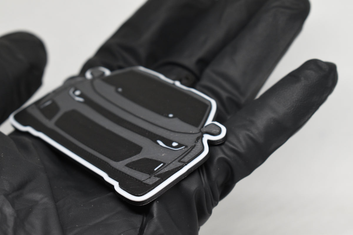 Side angle view showing 3D layered detail of space gray and black Chevrolet Camaro ZL1 keychain by LayerPlay Pocket Motors