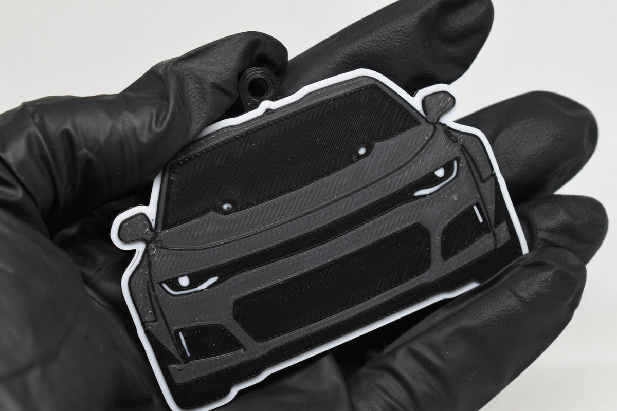 3D printed space gray and black Chevrolet Camaro ZL1 keychain held in hand, front view detail by LayerPlay Pocket Motors