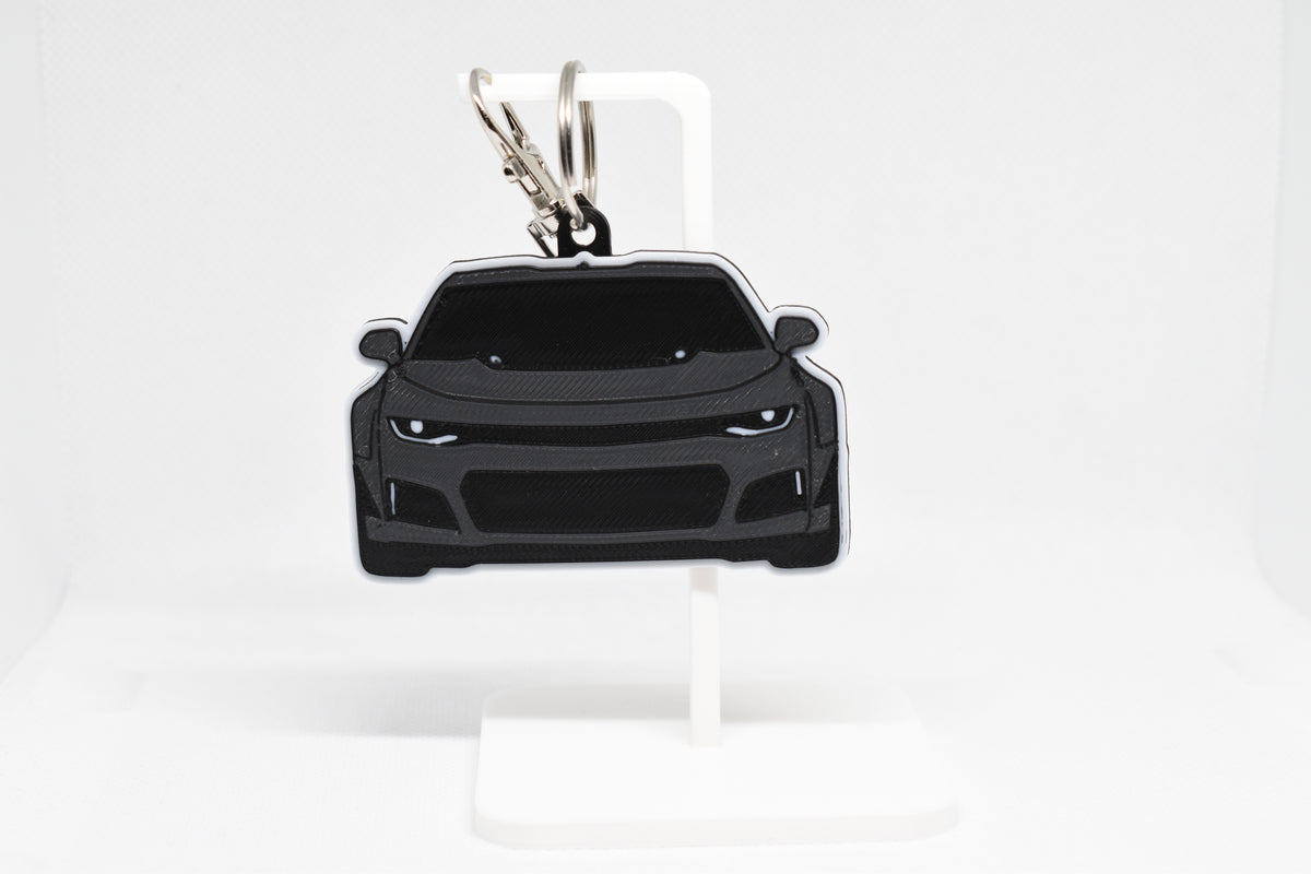 Pocket Motors Chevrolet Camaro ZL1 keychain displayed on a white stand with metal ring and clip.
