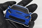 3D printed blue Chevrolet Corvette C7 keychain held in hand, front view detail by LayerPlay Pocket Motors