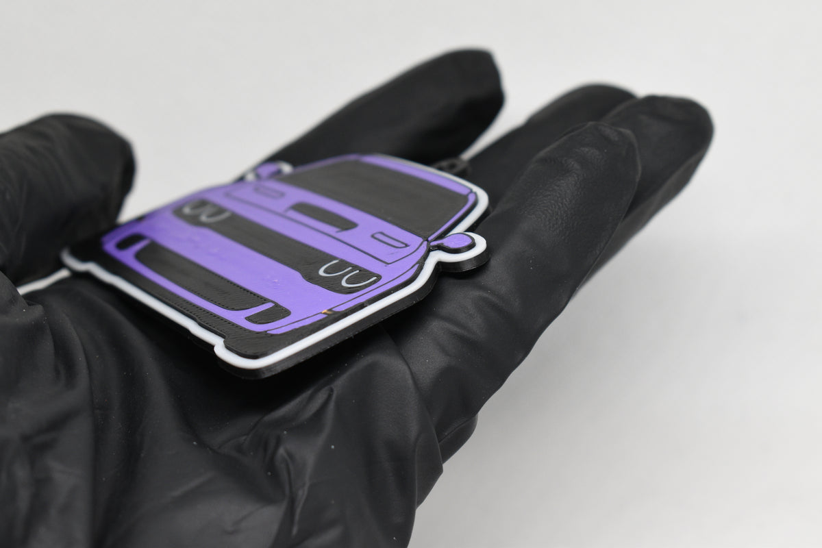 Side angle view showing 3D layered detail of purple Dodge Challenger Hellcat keychain by LayerPlay Pocket Motors