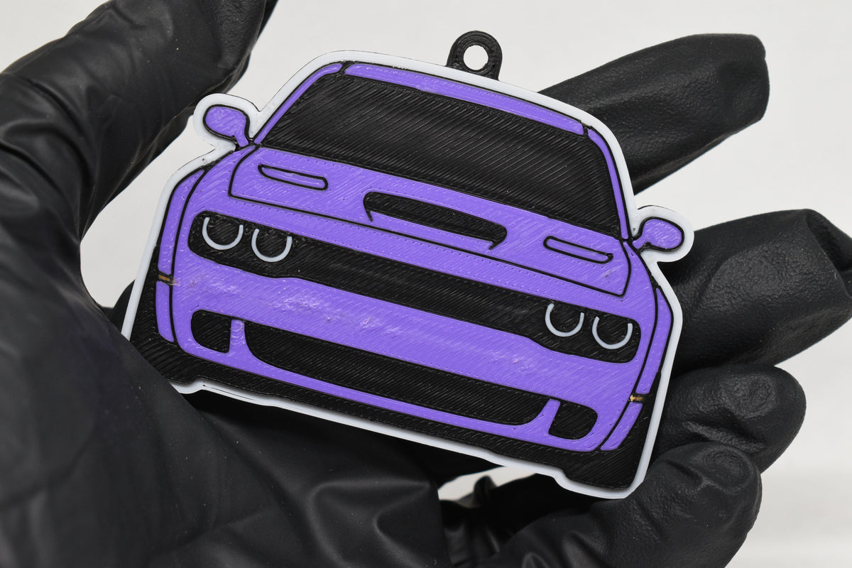 3D printed purple Dodge Challenger Hellcat keychain held in hand, front view detail by LayerPlay Pocket Motors