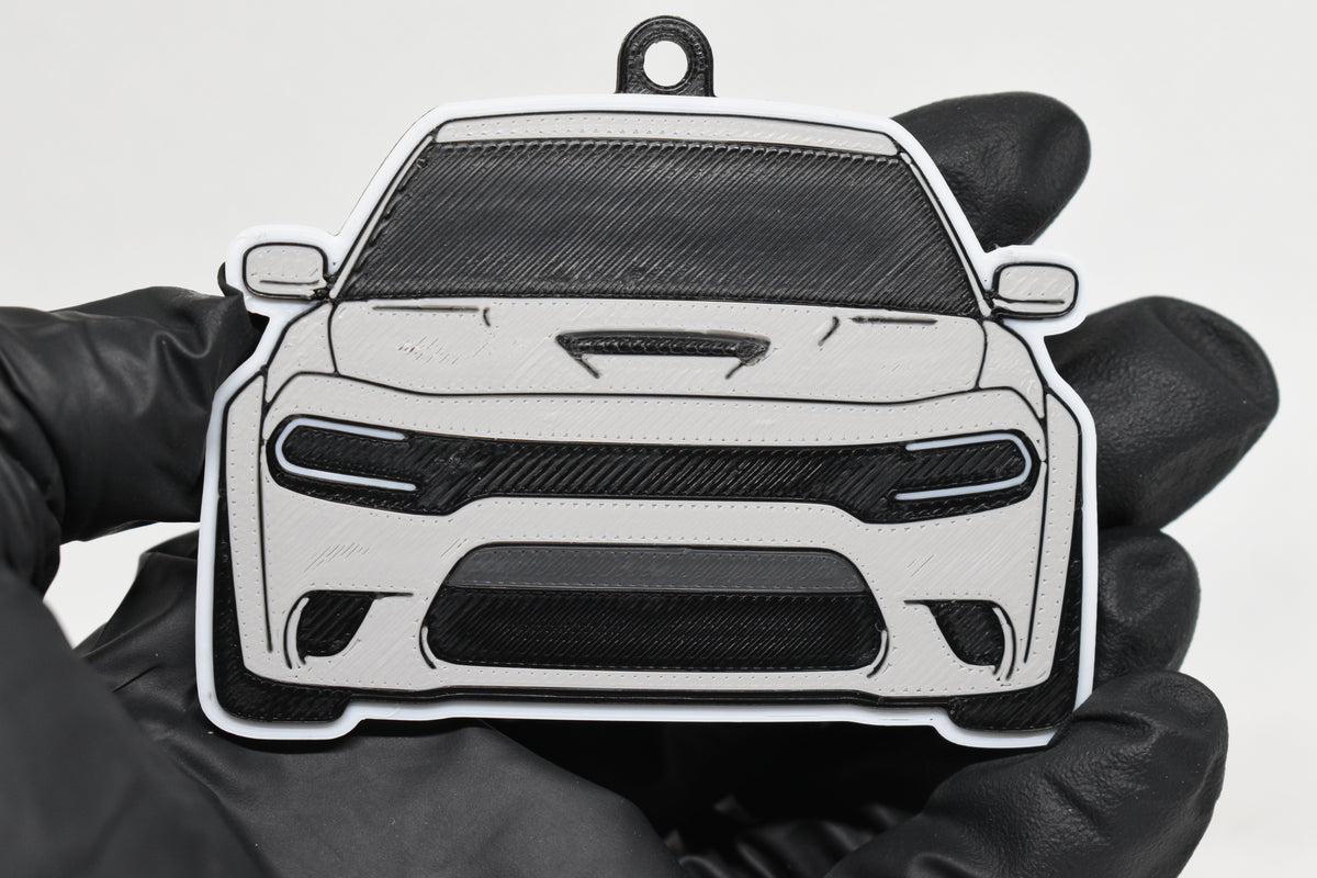 3D printed light gray Dodge Charger Hellcat keychain held in hand, front view detail by LayerPlay Pocket Motors
