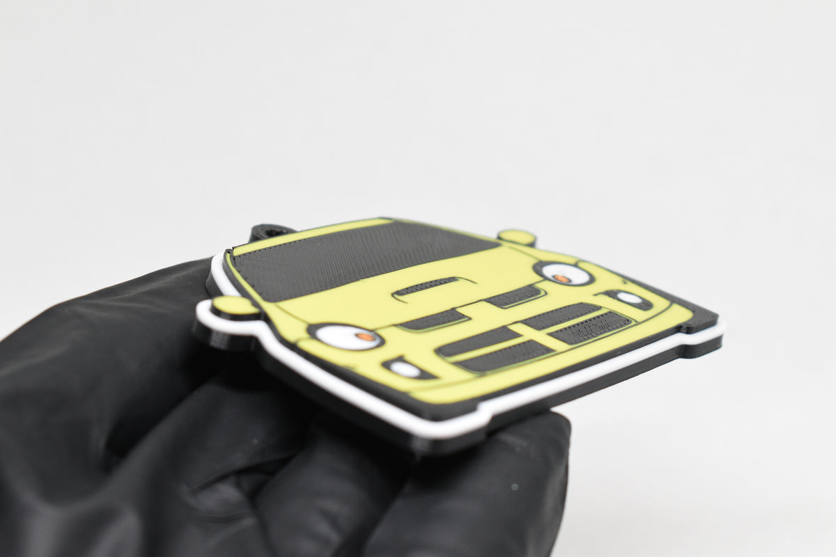 Side angle view showing 3D layered detail of yellow Dodge Neon SRT-4 keychain by LayerPlay Pocket Motors