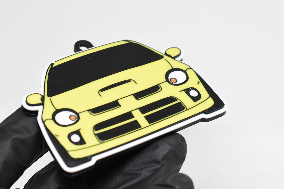 3D printed yellow Dodge Neon SRT-4 keychain held in hand, front view detail by LayerPlay Pocket Motors