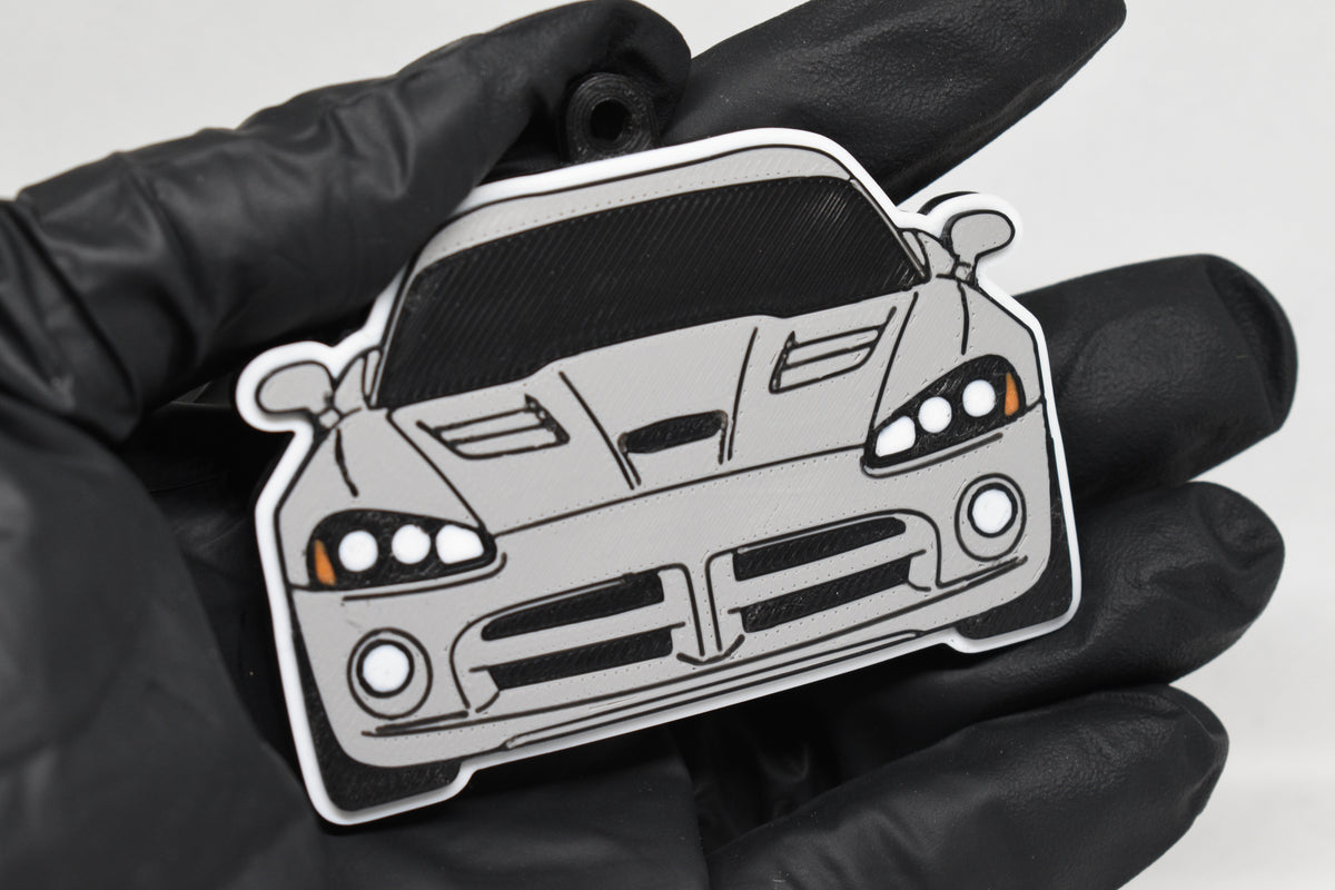 3D printed light gray Dodge Viper 4th Gen keychain held in hand, front view detail by LayerPlay Pocket Motors