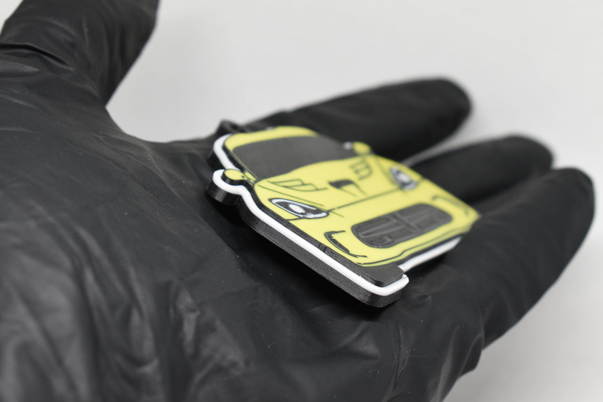 Side angle view showing 3D layered detail of yellow Dodge Viper 5th Gen keychain by LayerPlay Pocket Motors