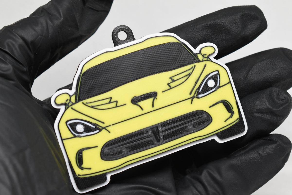 3D printed yellow Dodge Viper 5th Gen keychain held in hand, front view detail by LayerPlay Pocket Motors
