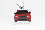 Pocket Motors Evo 10 keychain displayed on a white stand with metal ring and clip.