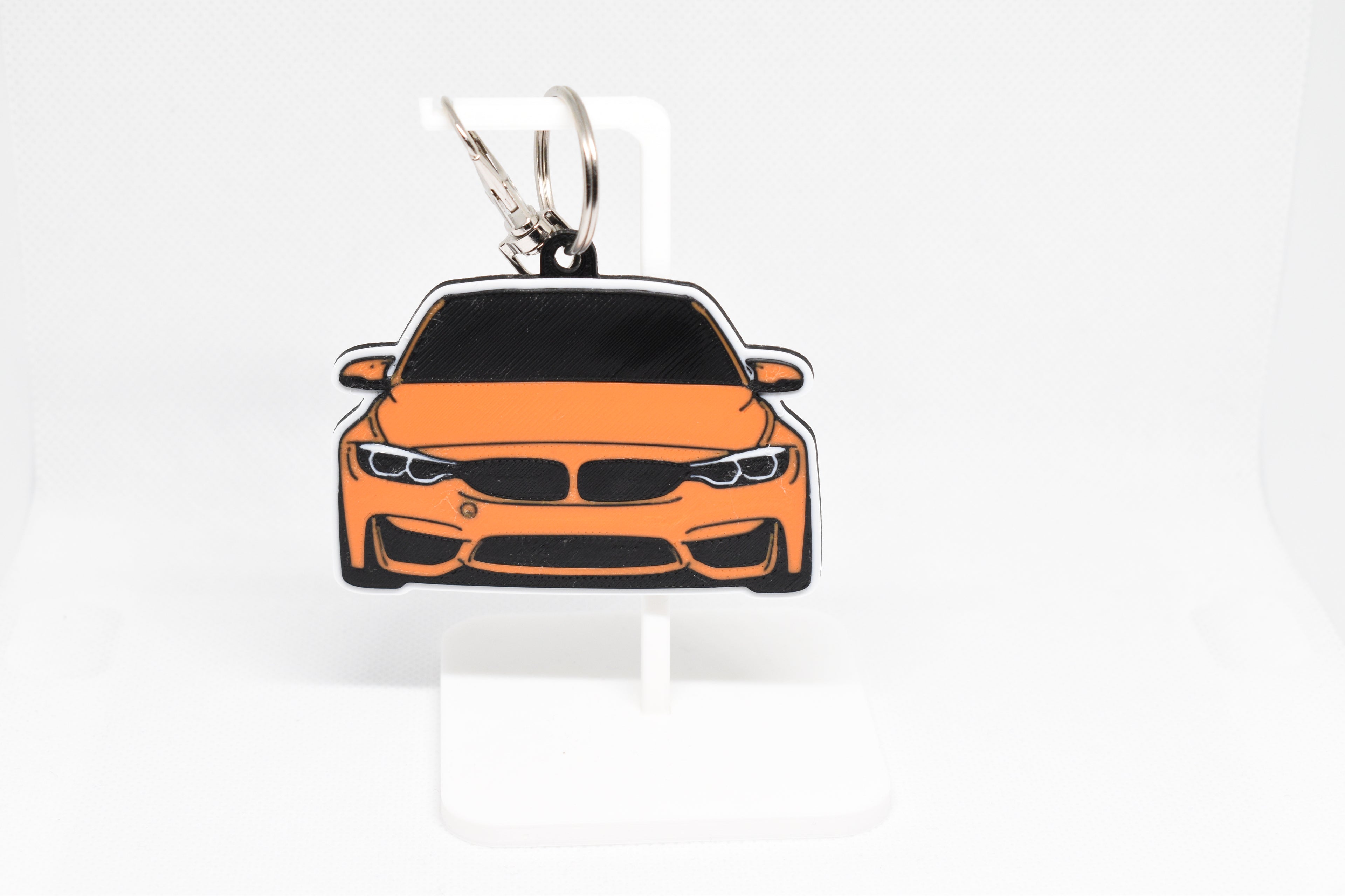 Pocket Motors F80 M3 keychain displayed on a white stand with metal ring and clip.