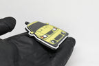Side angle view showing 3D layered detail of yellow Ford Mustang Cobra SN95 facelift keychain by LayerPlay Pocket Motors