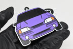 3D printed purple Ford Mustang Foxbody keychain held in hand, front view detail by LayerPlay Pocket Motors