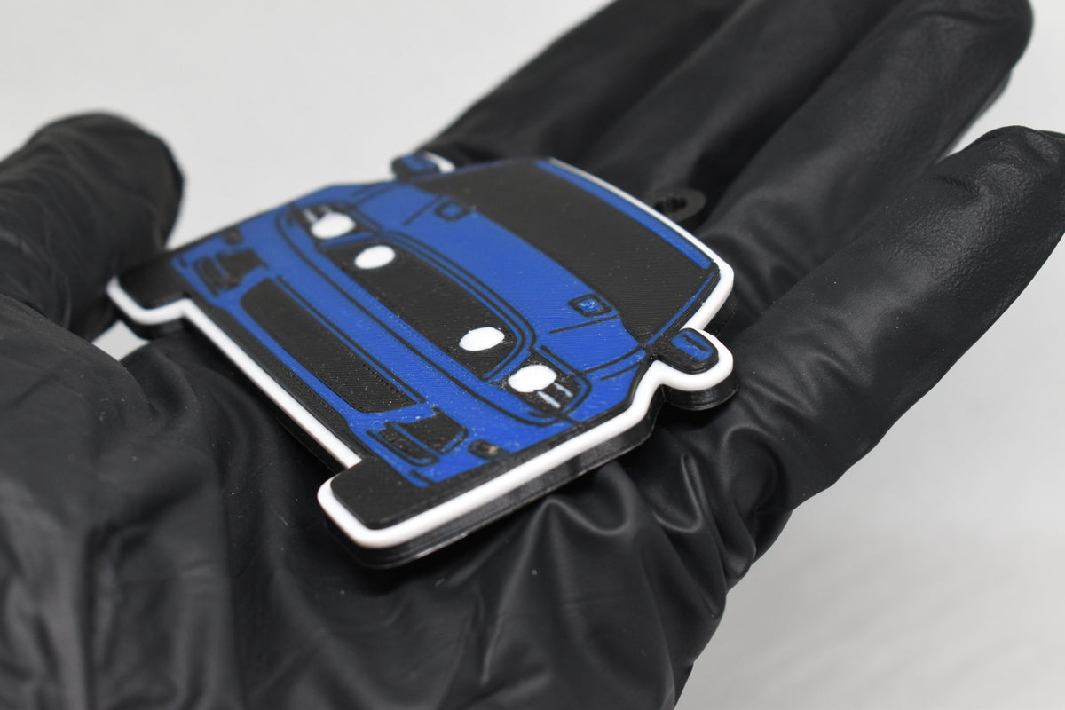 Side angle view showing 3D layered detail of blue Ford Mustang S197 GT facelift keychain by LayerPlay Pocket Motors