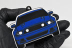 3D printed blue Ford Mustang S197 GT facelift keychain held in hand, front view detail by LayerPlay Pocket Motors