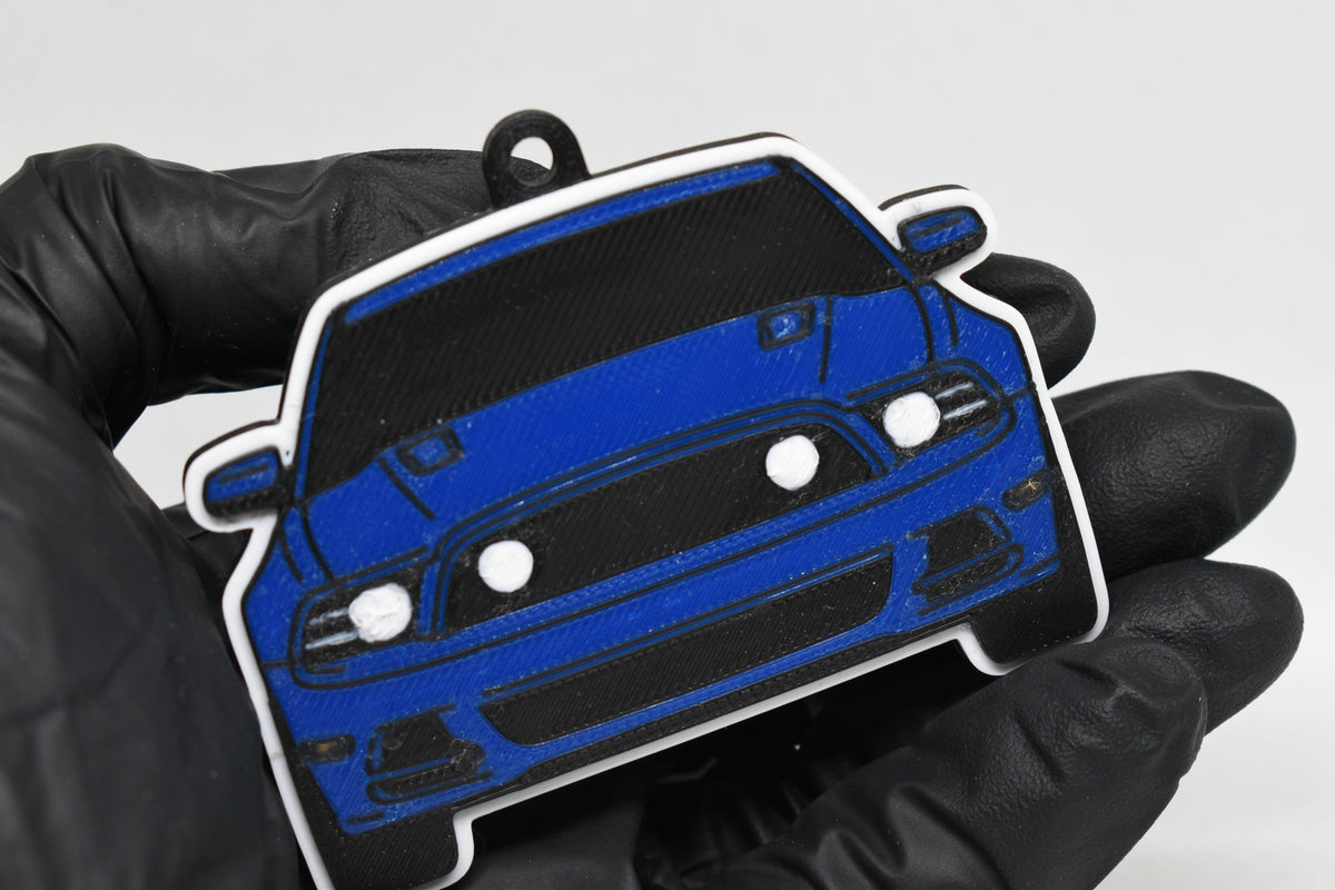 3D printed blue Ford Mustang S197 GT facelift keychain held in hand, front view detail by LayerPlay Pocket Motors
