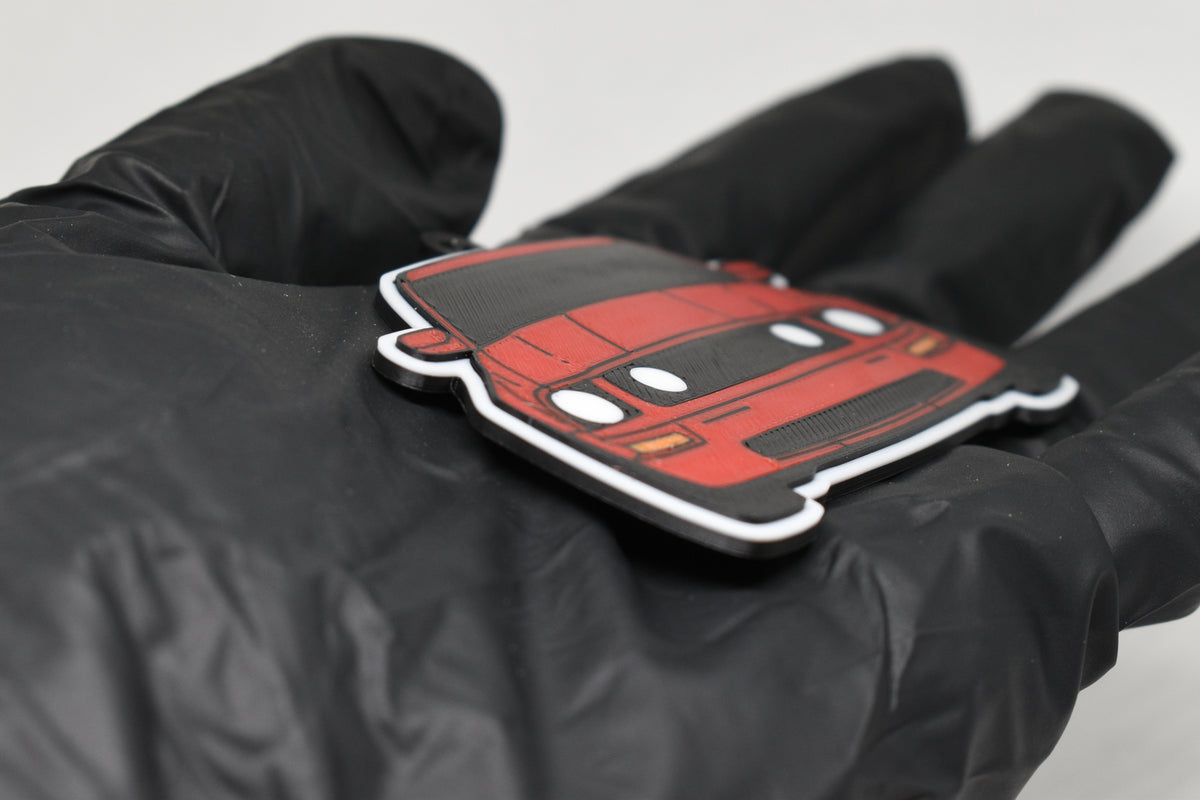 Side angle view showing 3D layered detail of red Ford Mustang S197 GT keychain by LayerPlay Pocket Motors