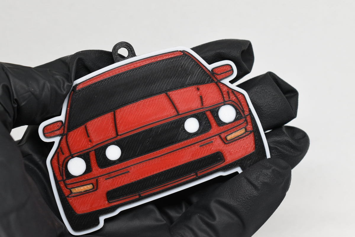 3D printed red Ford Mustang S197 GT keychain held in hand, front view detail by LayerPlay Pocket Motors