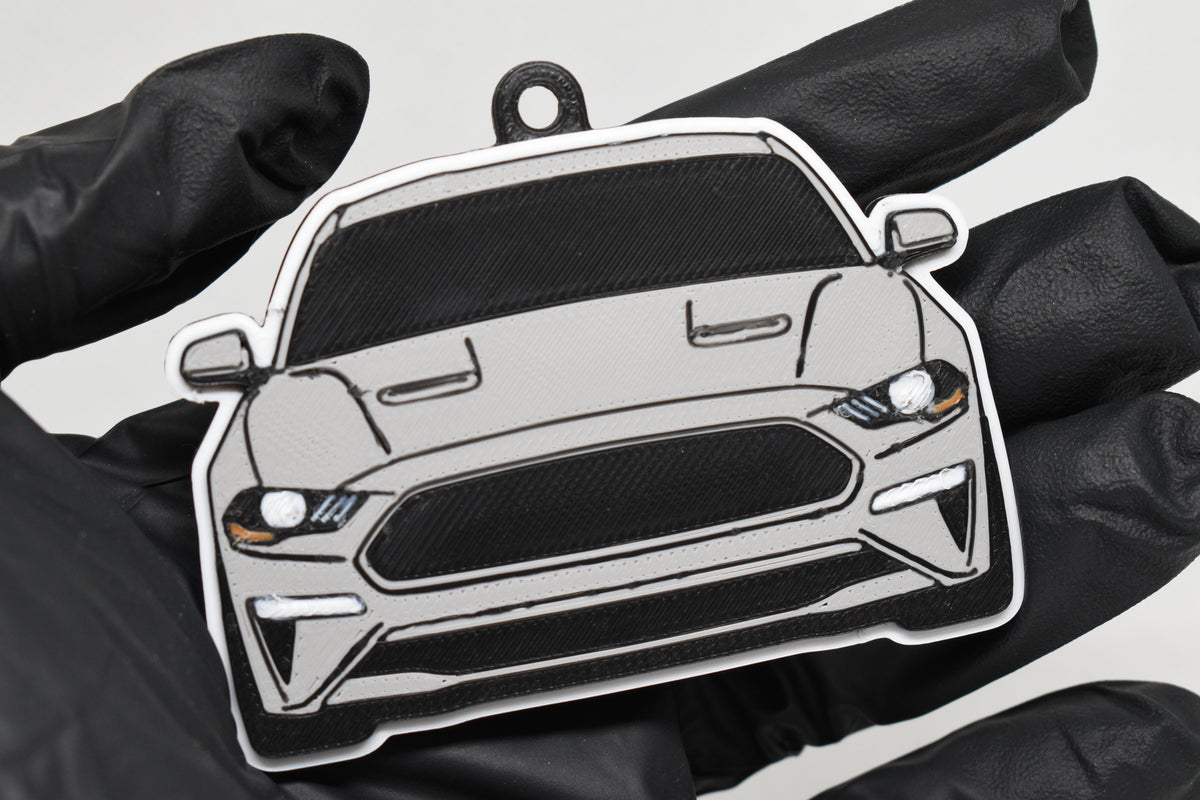 3D printed light gray Ford Mustang S550 facelift keychain held in hand, front view detail by LayerPlay Pocket Motors