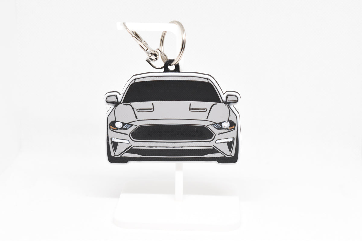 Pocket Motors Ford Mustang S550 facelift keychain displayed on a white stand with metal ring and clip.