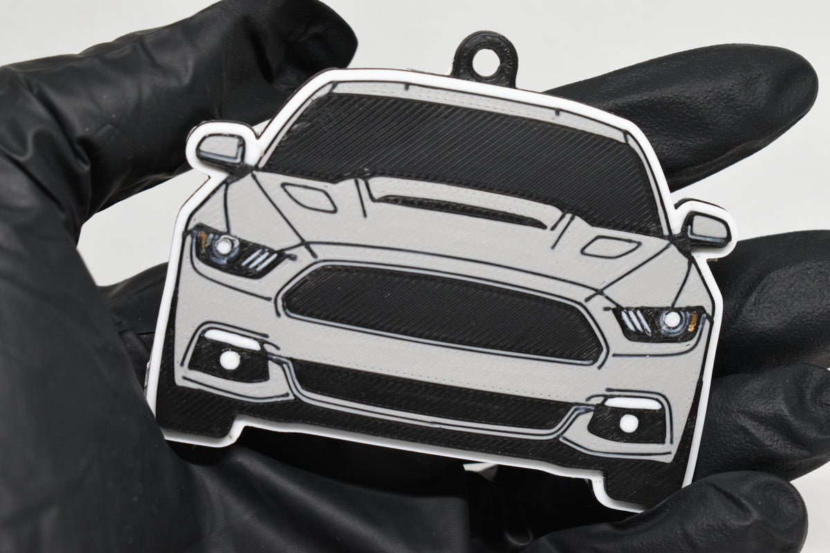 3D printed light gray Ford Mustang S550 keychain held in hand, front view detail by LayerPlay Pocket Motors