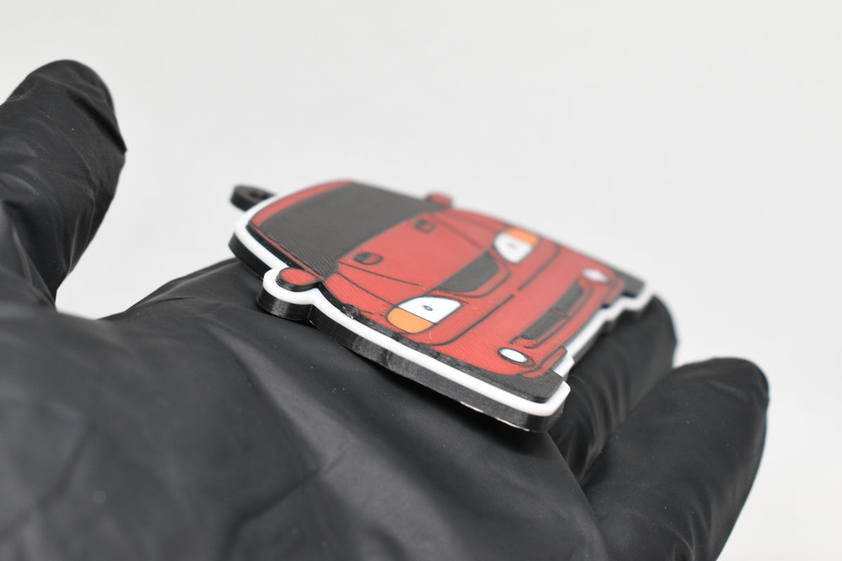 Side angle view showing 3D layered detail of red Ford Mustang SN95 Cobra keychain by LayerPlay Pocket Motors