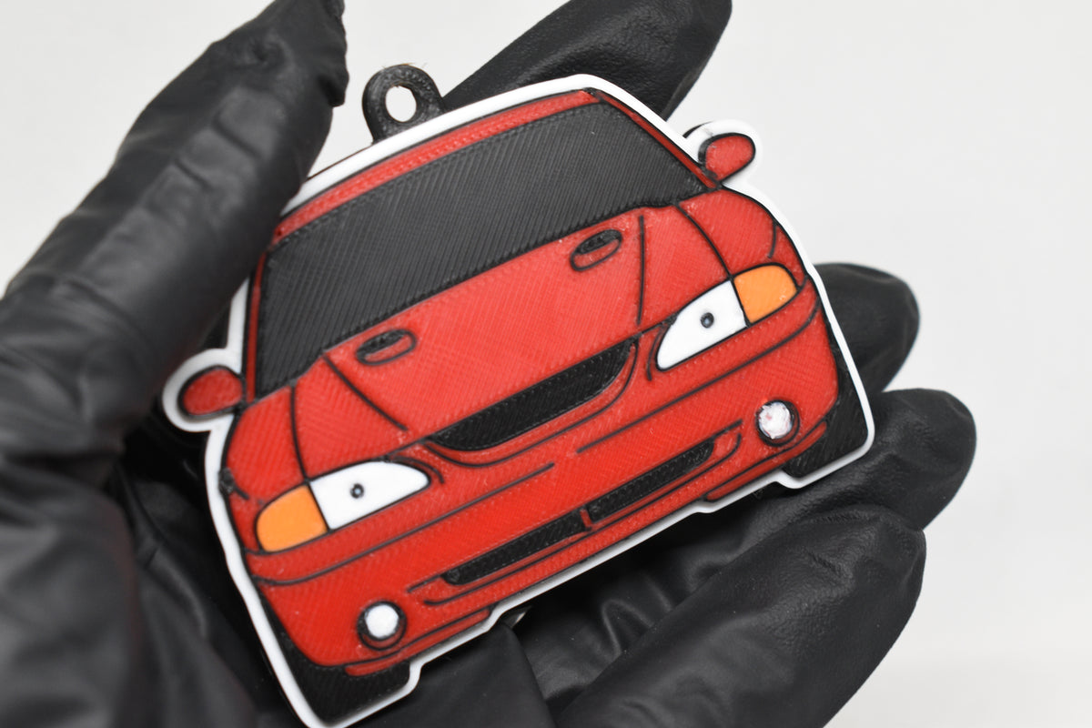 3D printed red Ford Mustang SN95 Cobra keychain held in hand, front view detail by LayerPlay Pocket Motors