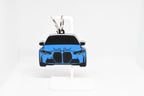 Pocket Motors G80 M3 keychain displayed on a white stand with metal ring and clip.