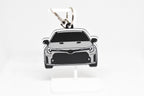 Pocket Motors GR Corolla pre‑facelift keychain displayed on a white stand with metal ring and clip.