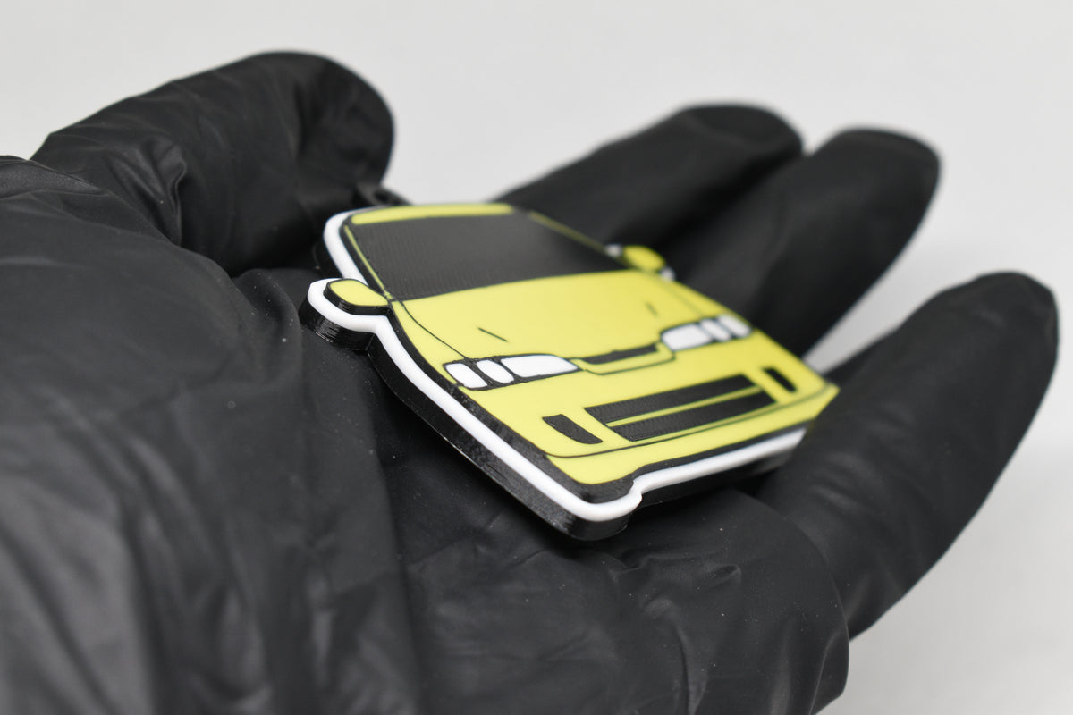 Side angle view showing 3D layered detail of yellow JDM Honda Integra DC2 keychain by LayerPlay Pocket Motors
