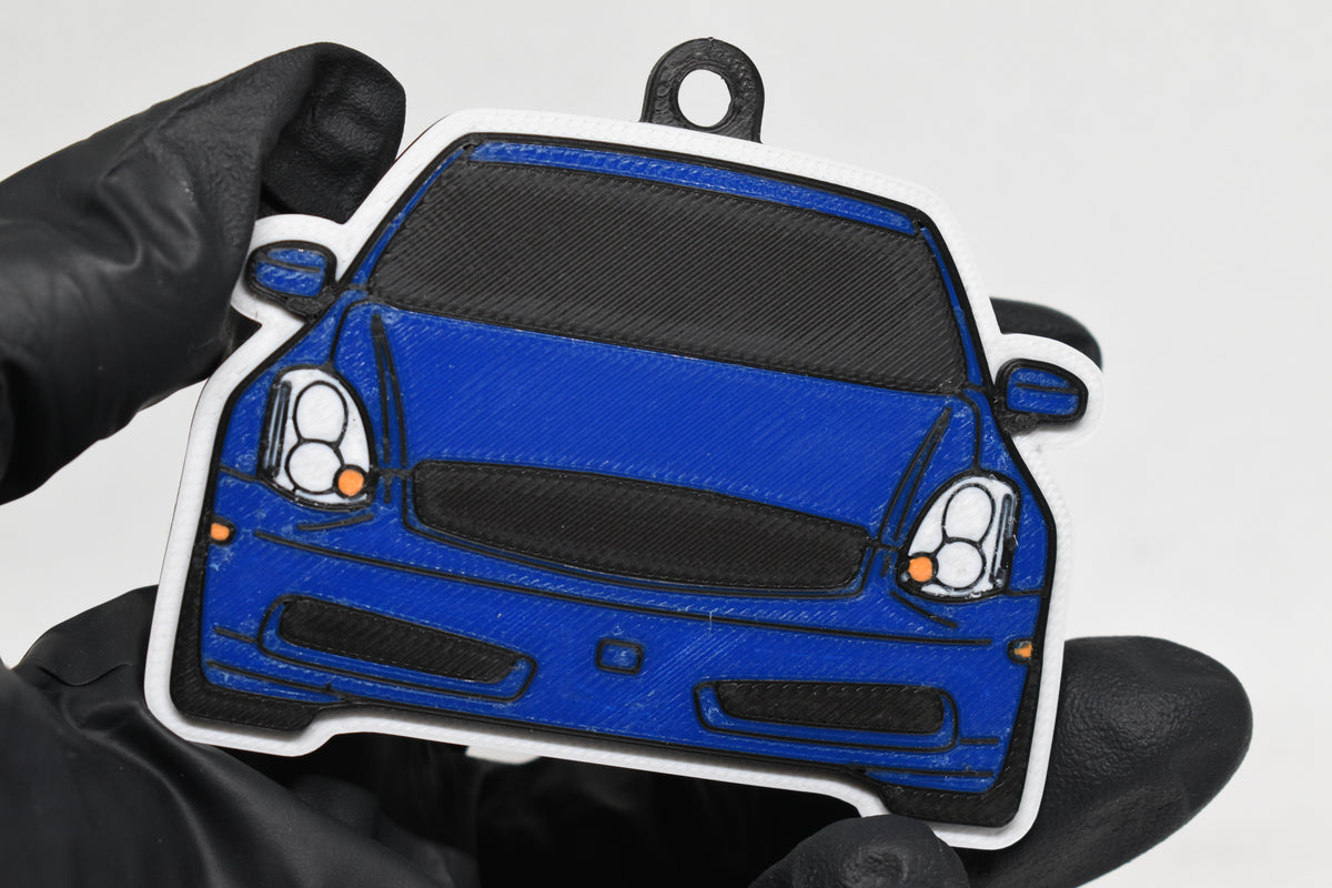 3D printed blue Infiniti G35 Coupe keychain held in hand, front view detail by LayerPlay Pocket Motors