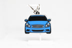 Pocket Motors infiniti G37 Coupe keychain displayed on a white stand with metal ring and clip.