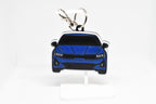 Pocket Motors K5 keychain displayed on a white stand with metal ring and clip.