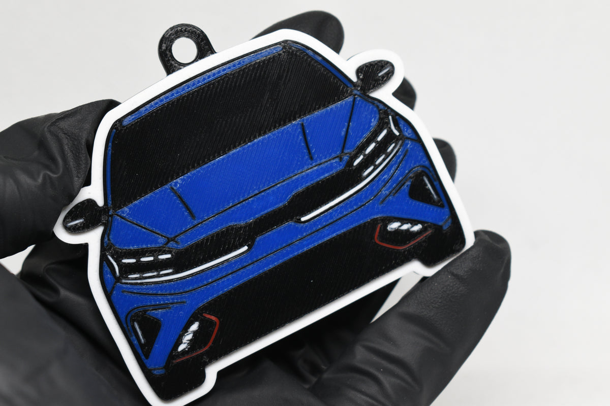 3D printed blue Kia Forte GT keychain held in hand, front view detail by LayerPlay Pocket Motors