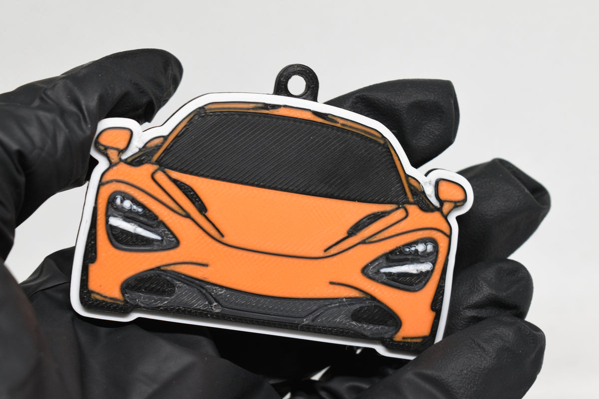 3D printed orange McLaren 720S keychain held in hand, front view detail by LayerPlay Pocket Motors
