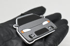 Side angle view showing 3D layered detail of light gray Mitsubishi Eclipse 2nd Gen keychain by LayerPlay Pocket Motors