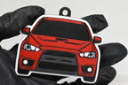 3D printed red Mitsubishi Lancer Evolution 10 keychain held in hand, front view detail by LayerPlay Pocket Motors