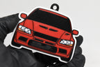 3D printed red Mitsubishi Lancer Evolution 7 keychain held in hand, front view detail by LayerPlay Pocket Motors